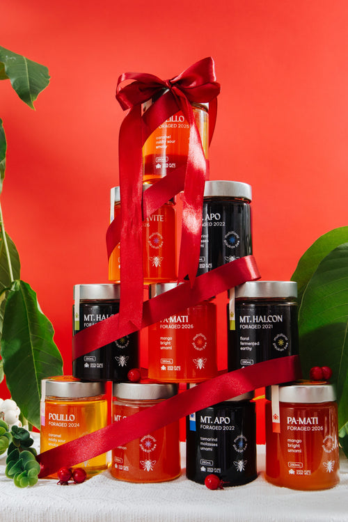 Ten Hapag 280mL jars stacked into a tree with a red ribbon